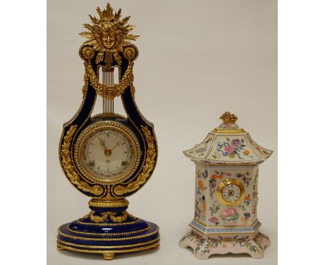 A modern Victoria & Albert lyre shaped mantel clock, on a blue ground with gilt decoration; together with a clock of 100 flow