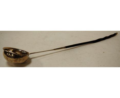 An early 19th century white metal toddy ladle, having spiral turned whalebone handle