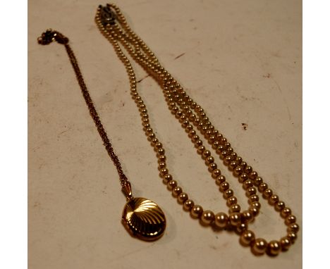 A ladies rolled gold pendant on finelink chain together with a two row pearl necklace