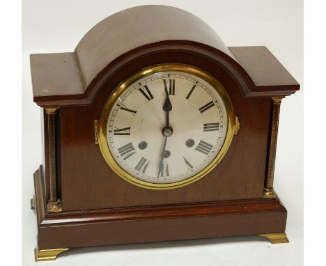 An early 20th century continental mahogany cased mantel clock having silvered dial with Roman numerals and eight day movement
