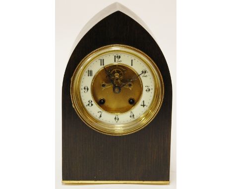 An early 20th century ebonised cased lancet shaped mantel clock having enamelled dial with Arabic numerals, eight day cylinde