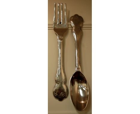 An oversized restaurant advertising fork and spoon 