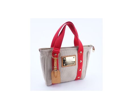 Louis Vuitton Beige/Red Canvas Antigua Cabas PM Tote. Golden brass hardware, striped fabric interior with patch pockets. Lugg