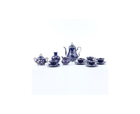 Thirteen (13) Piece German Cobalt Blue Porcelain and Pure Silver Tea Set. Includes: five cups, four saucers, creamer, covered