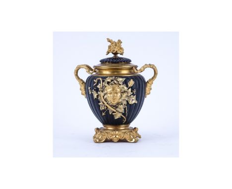 Neoclassical Style Gilt Brass and Painted Covered Urn with Bacchus Motif. Light rubbing to gilt overall good condition. Measu