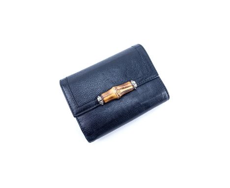 Gucci Black Grained Leather Bamboo Trifold Wallet. Bamboo and gold tone hardware. Numerous slots and pockets. Labeled appropr