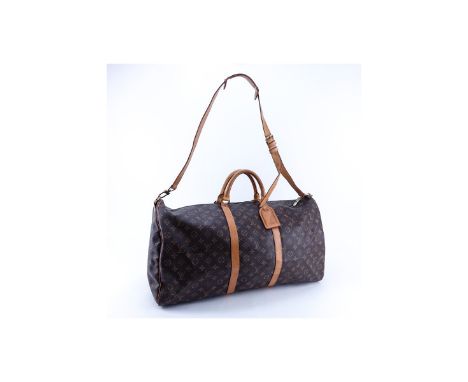 Louis Vuitton Brown Monogram Coated Canvas Keepall Bandouliere 50. Golden brass hardware. The interior of brown canvas. Vache