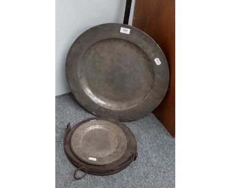 An 18th Century Pewter Charger; a pair of pewter plates; a skillet; a brass warming pan and a brass cover for a warming pan.