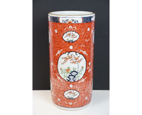 Chinese porcelain stick stand decorated in enamels with panels of blossom trees on a red ground with cloud decoration, 46cm h