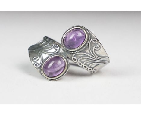 A ladies silver double amethyst cabochon dress ring, marked 925 to the inner shank. 