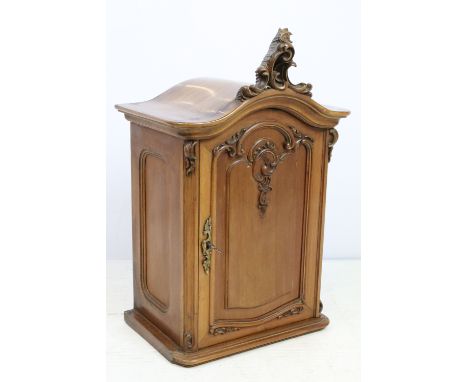 Early 20th century Continental ornately carved small cabinet with single door, shelf to interior, with key, 57cm high x 34.5c