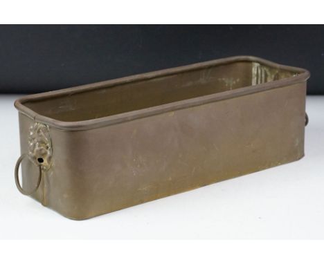 Copper planter of rectangular form, with twin lion mask handles and rolled upper rim. Measures approx 35cm long 