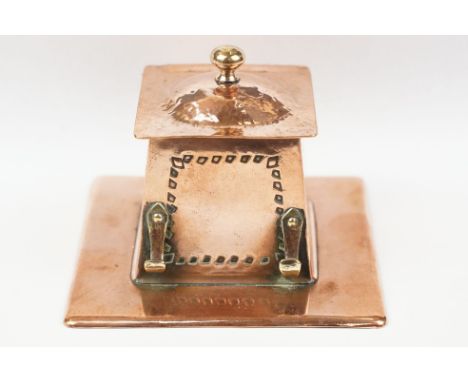 Arts and Crafts Copper Square Inkwell, the hinged lid opening to a ceramic inkwell, pen hooks to side, 10cm wide 