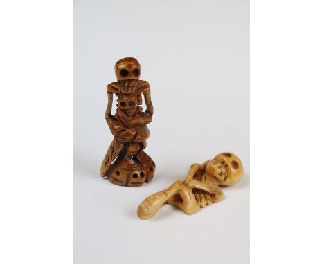 Two carved Netsuke in the the form of skeletal figures. 