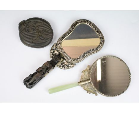 An antique Japanese ornately carved fruit halves with internal figural carving together with two oriental hand mirrors to inc