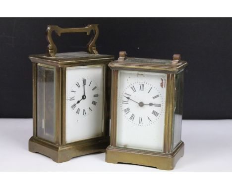 Two vintage brass cased carriage clocks with beveled glass panels and white enamel dials. 