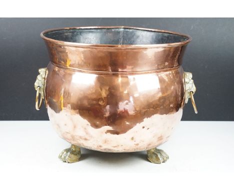 Large Antique Copper Cauldron type Planter or Jardiniere, with rolled rim and brass Lion Mask ring handles, raised on three l