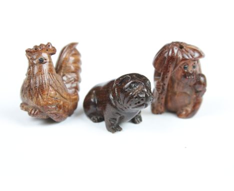 Three Chinese carved wooden netsuke in the form of a Monkey, dog and cockerel. 