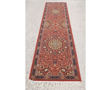 Super Keshan hand-made red ground carpet / runner of geometric design, approximately 350 x 90cm 