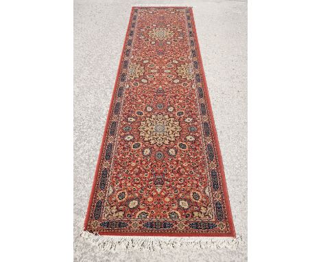 Super Keshan hand-made red ground carpet / runner of geometric design, approximately 350 x 90cm 