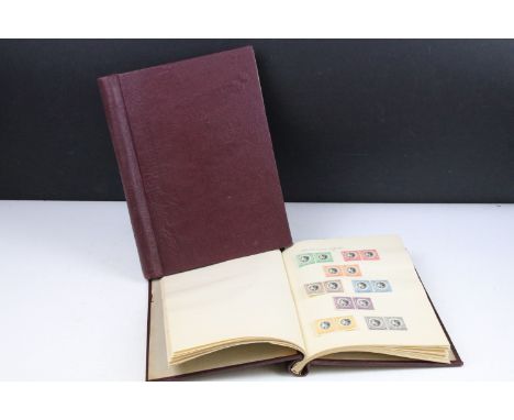 A stamp album containing stamps marking the silver jubilee of King George V from the UK and Commonwealth together with an alb