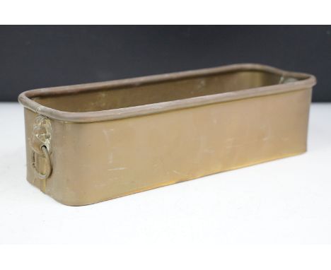 Brass planter of rectangular form with twin lion mask loop handles and rolled upper rim, approx 29cm long 