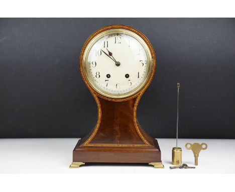 Early 20th century inlaid mahogany balloon form mantel clock, raised on four gilt metal bracket feet. Measures approx 32cm hi