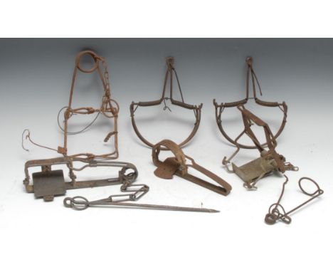 Gamekeeping - a 19th century gin trap, by C Homes, 26cm long; another, egg shaped jaws, 23cm long; a rabbit trap; others (7) 