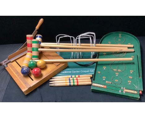 A lawn croquet set, soft carry case; a bagatelle game; a Dryad guillotine (3) 