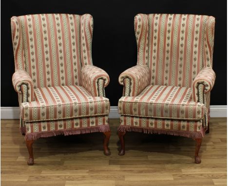 A pair of early 20th century wingback armchairs, stuffed-over upholstery, squab cushion, cabriole forelegs, pad forefeet, 104