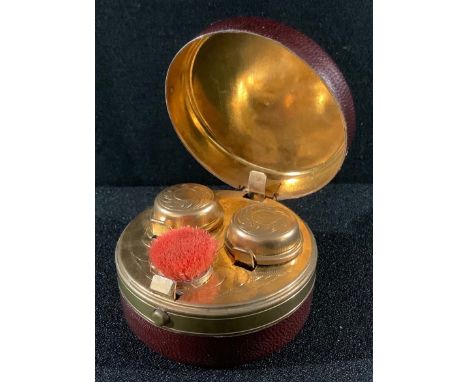 A Victorian tooled leather twin-compartment travelling inkwell, 7cm diam, c.1890 