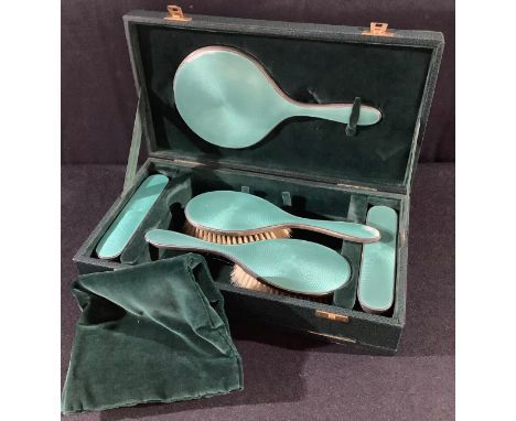 A George VI silver and enamel five piece dressing table set, London 1938, cased 