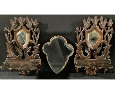 A pair of Victorian carved wood shelf brackets with mirrors, 29cm high; a gilt framed shaped mirror (3) 