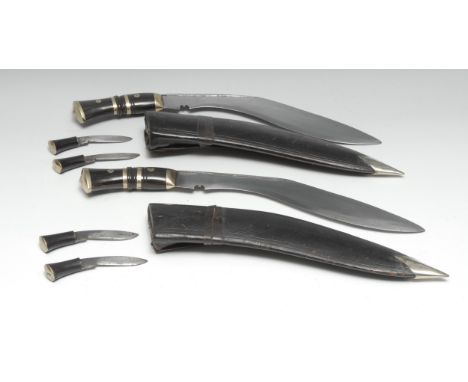 A Nepalese or Indian kukri, 29.5cm blade, horn grip, leather scabbard, skinning knives en suite, 45cm long overall; another, 