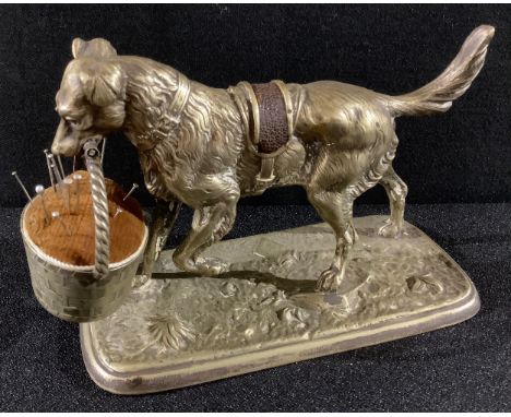 A Victorian cast metal pin cushion modelled as a dog with basket, kite mark to maquette, 15cm long 