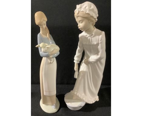 A Lladro figure, girl holding a lamb, 27cm high; a Nao by Lladro figure, bedtime foot bath, 29cm high (2) 