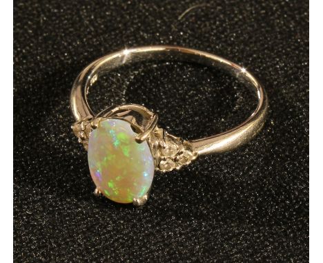 An 18k white gold opal ring, the shoulders accented with diamonds, ring size R, 3.78g 