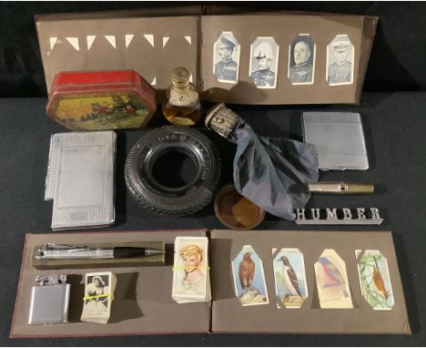 A novelty Ronson cigarette lighter pen, boxed; an India Balloon advertising tyre ashtray; a miser's purse; a Humber car badge