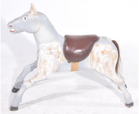 A vintage early to mid 20th Century painted wooden fairground horseThe carved and painted wooden horse applied with a leather