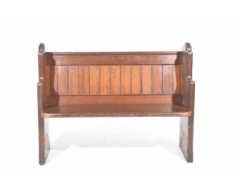 A early 20th Century pitch pine pew of small proportions 
With a panel back supported on two shaped bracket supports, 123cm w