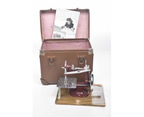 A vintage Essex miniature sewing machineThe red painted metal and chromed small side sewing machine on wooden plinth with ori