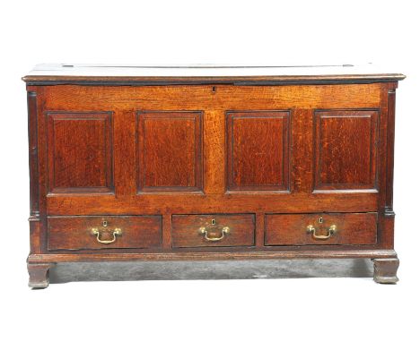 An 18th Century oak mule chestThe rectangular hinged top above four invert moulded panels and a pair of lower frieze drawers 