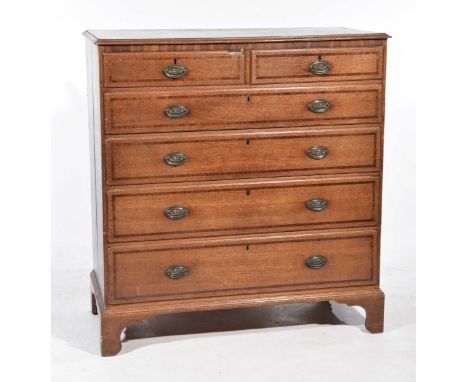 A Georgian oak and mahogany cross banded chest of drawers
With a rectangular moulded and cross banded top above two short and