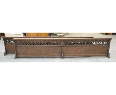 A pair of Victorian oak Pugin Influence prayer stallsEach stall with an angled book rest above an open work quatrefoil frieze