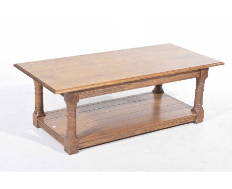 A contemporary light oak coffee tableThe rectangular moulded top supported on four ring turned legs with a simulated plank lo