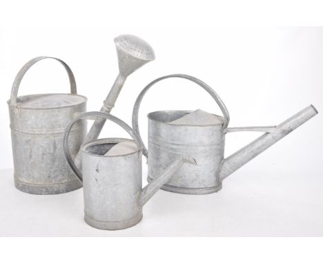 A set of three vintage galvanized watering cansEach of typical form with elongated spout and loop handle, one with rose sprin