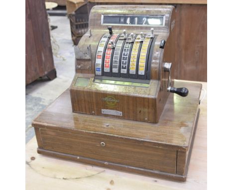 A vintage 1960's National cash registerThe wooden veneered till with various monetary dials and chromed levers, stamped Natio