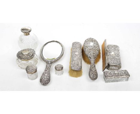 A collection of ladies silver backed dressing table items To include mirror, comb, hairbrush, clothes brush, glass Silver lid