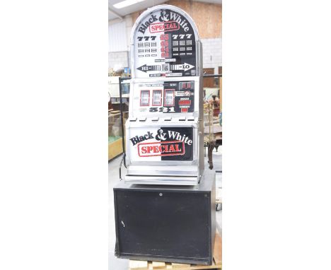 A vintage black and white special fruit machine by Barcrest, circa late 1990'sOf typical form mounted on a black plinth base 