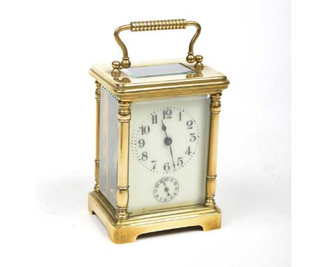 A late 19th Century French full glass brass carriage alarm clock
The white enamelled dial with Arabic numerals and small subs